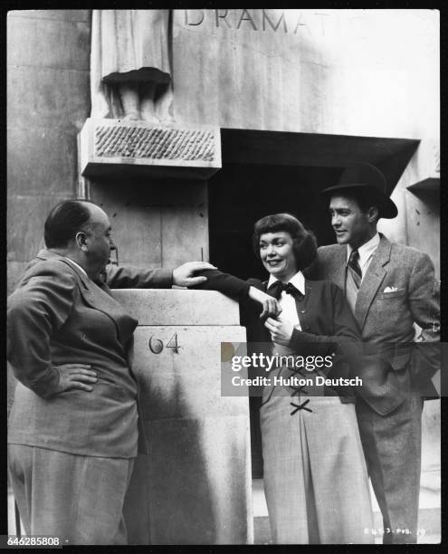 American film actress Jane Wyman with British actor Richard Todd and film director Alfred Hitchcock , outside the Royal Academy of Dramatic Art in...