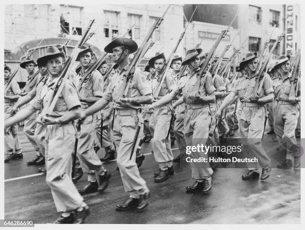Anzacs Off To Korea. Troops of the First Battalion, Royal Australian Regiment pass the Town Hall saluting base during the street march prior to...