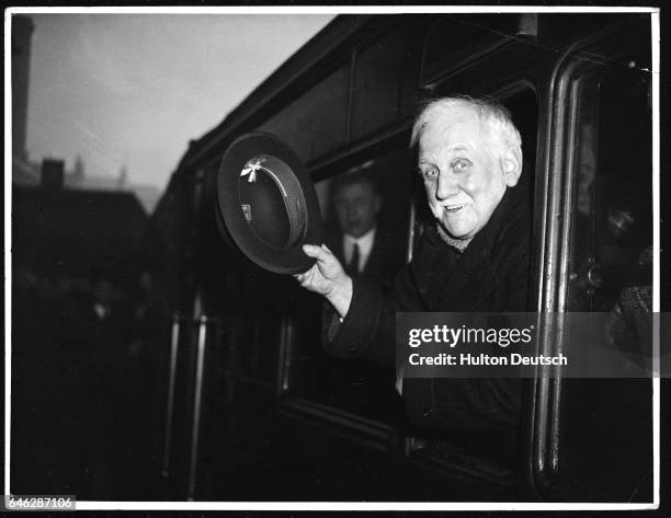 The Labour politician George Lansbury waves as he leaves Victoria Station en route for Europe.