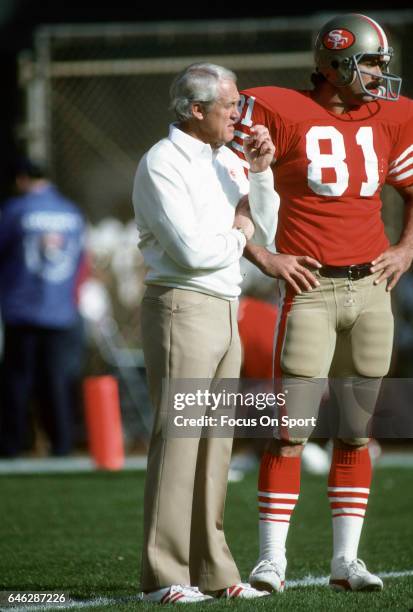 Head coach Bill Walsh of the "nSan Francisco 49ers talks with tight end Russ Francis during pregame warm ups prior to the start of an NFL Football...