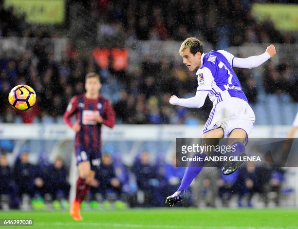 Real Sociedad's forward Juanmi Jimenez heads the ball to score his team's first goal during the Spanish league football match Real Sociedad vs SD...