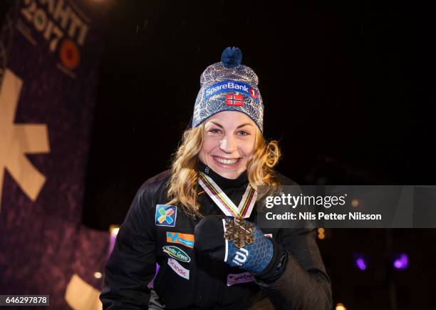 Astrid Uhrenholdt Jacobsen of Norway shows her bronze medal during the medal ceremony following the women's cross country distance during the FIS...