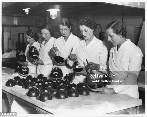 Group of women filling and decorating Easter Eggs.