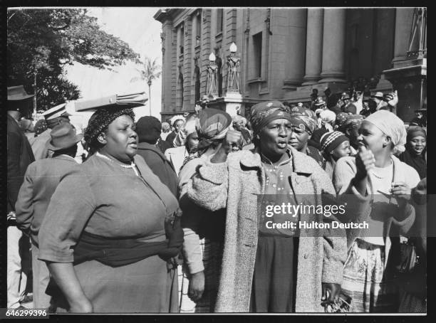 South African women at Durban law courts on charges of public violence following disturbances which broke out at municipal beer halls where beer was...