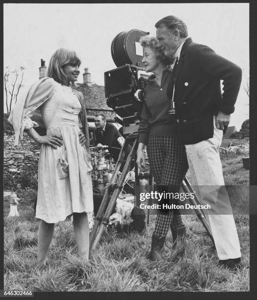 Actress Hayley Mills talking to her father John Mills and writer Mary Hayley Bell during location filming of the film Bat with Baby Faces in...