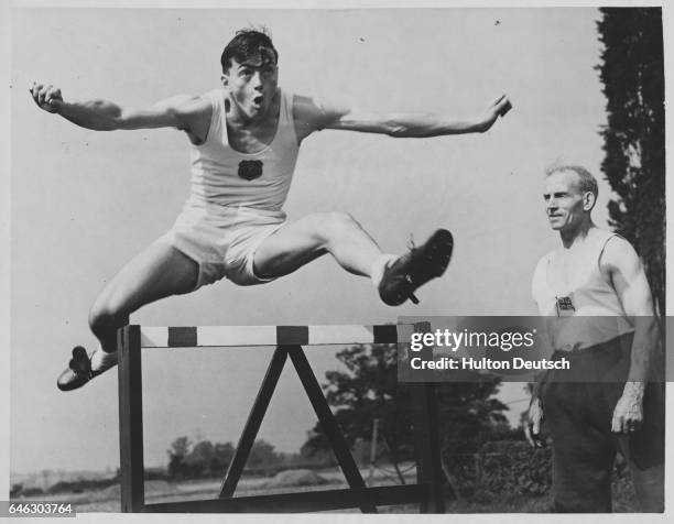 Jock Dalrymple, a former javelin, discus and hammer champion coaches his son. Although only 18, he has already thrown for the A.A.A..