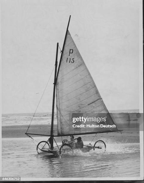 Sand Yachting On Belgium's Beaches. The longshoreman on the Belgian beaches lets out sand yachts in the same way that the English boatman hires out...