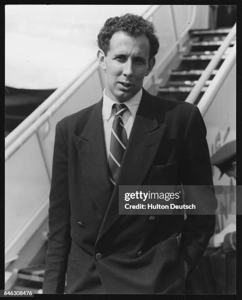 The Australian athlete John Landy, holder of the world mile record, arrives at London's Heathrow Airport.