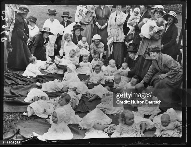 Mothers and babies await the judging at a baby show in Chiswick.
