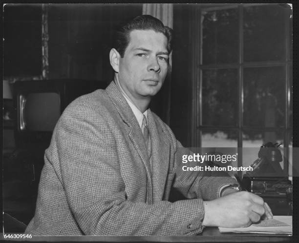 The former King of Romania, Michael, in exile at his desk in his study at Ayot House, where he lives with his wife and three daughters. | Location:...