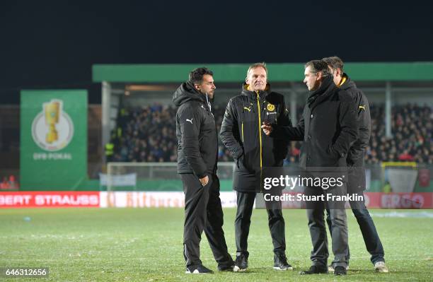 Ismail Atalan, head coach of Lotte talks with Hans Joachim Watzke, CEO of Dortmund and Michael Zorc, Sports director of Dortmund on the pitch as the...