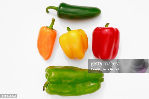 bell peppers on white - orangefarbige paprika stock-fotos und bilder