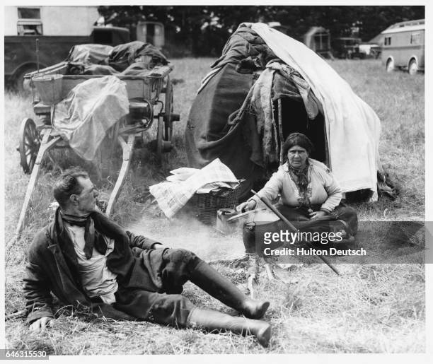Woman cooks outside a tent on Epsom Downs during Derby week.