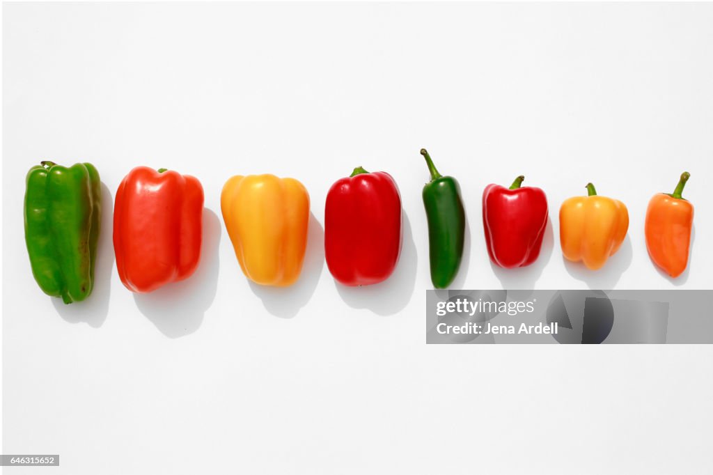 Line of Bell Peppers on White