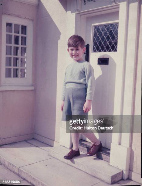 The young Prince Charles outside the little Welsh Cottage at the Royal Lodge at Windsor.