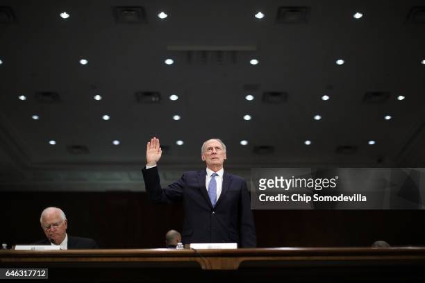 Former U.S. Senator Dan Coats is sworn in during his confirmation hearing before the Senate Select Intelligence Committee to be the next Director of...