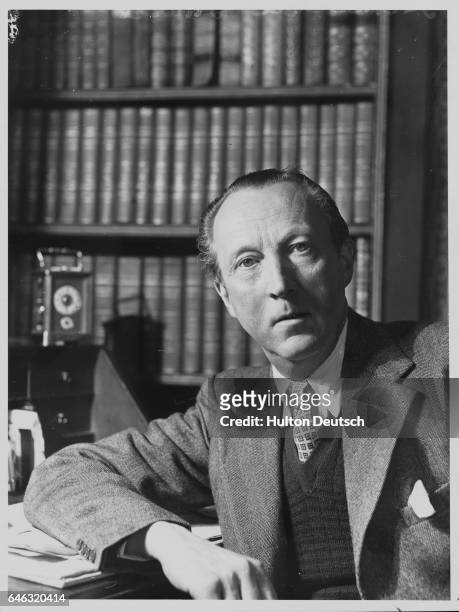 The English writer and art critic Sacheverell Sitwell sits at his desk, ca. 1950-1960.