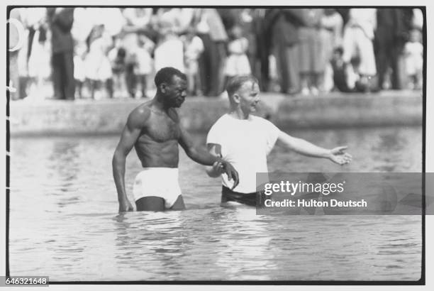 Jehovah's Witness member receives his baptism by immersion in water at Hyde Park in London.