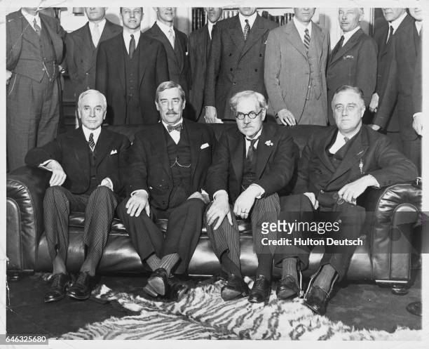 Sir Ronald Lindsay, U.S. Secretary of State Cordell Hull, British Prime Minister Ramsay MacDonald, and U.S. President Franklin D. Roosevelt.