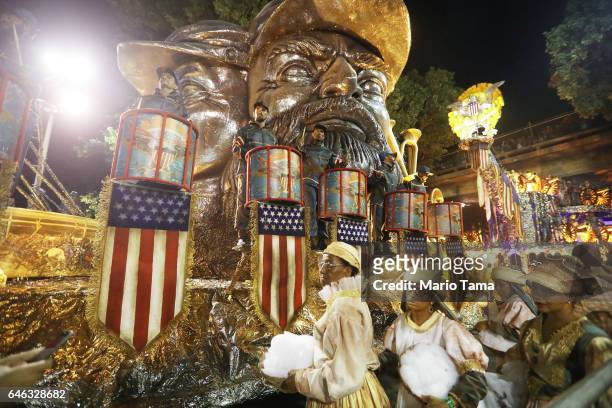 Revelers from the Tijuca samba school prepare to perform on a U.S.-themed float outside the Sambodrome in the early morning hours during Carnival...