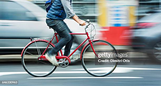 man cycling on red bicycle in street with movement - cyklist bildbanksfoton och bilder