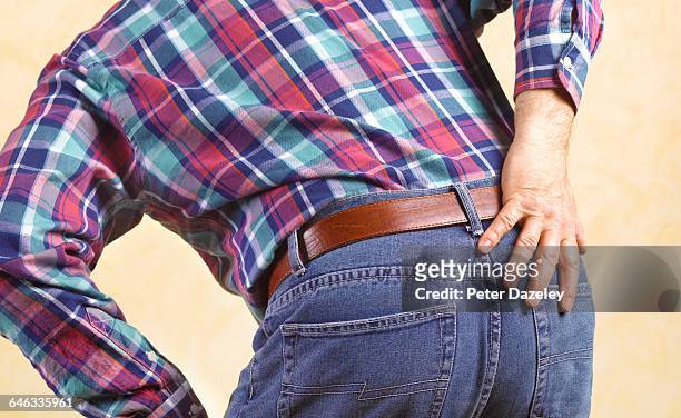 man in pain - bending over stock pictures, royalty-free photos & images