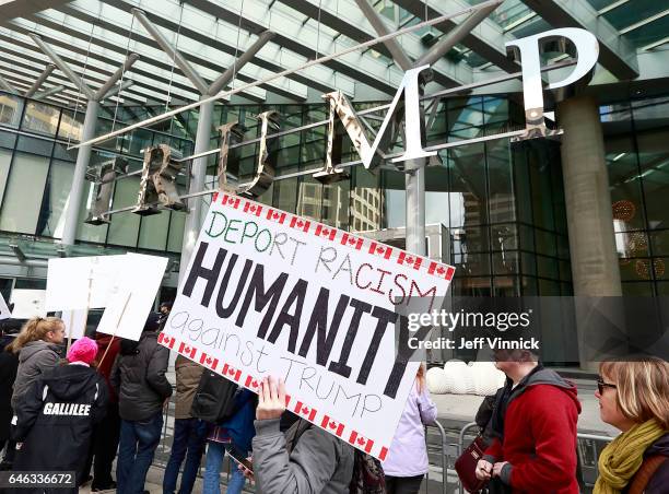 Protestors gather outside at the front of the Trump International Tower & Hotel during the official opening on February 28, 2017 in Vancouver,...