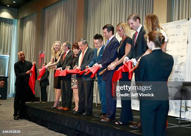 Donald Trump Jr. And Eric Trump participate in a ribbon cutting during a ceremony for the official opening of the Trump International Tower & Hotel...