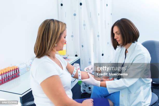 nurse taking blood sample - blood stock pictures, royalty-free photos & images