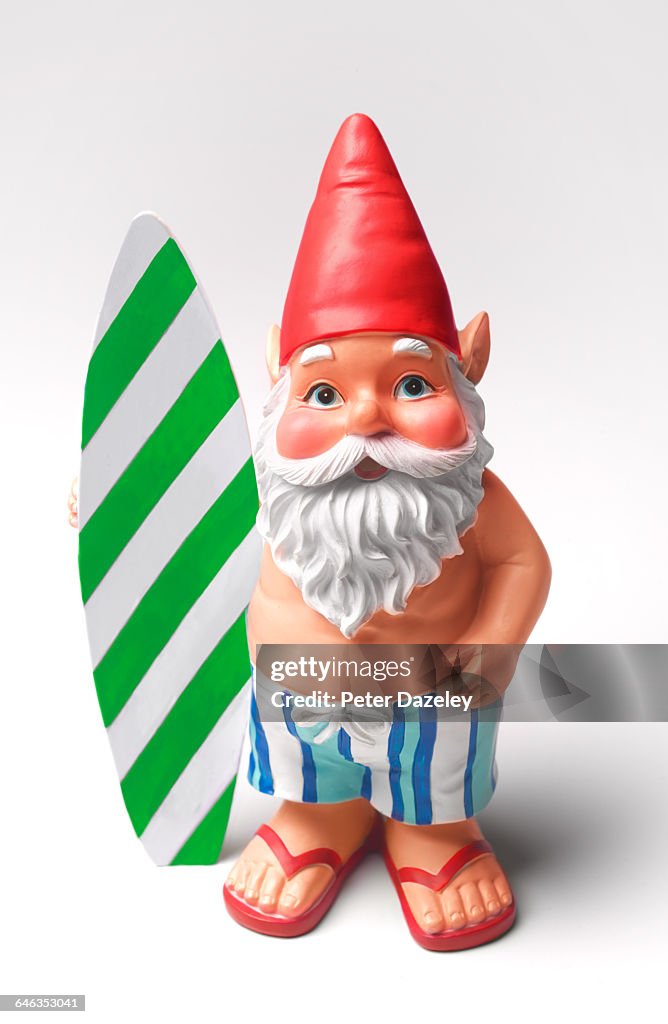 Sunburnt gnome with surfboard