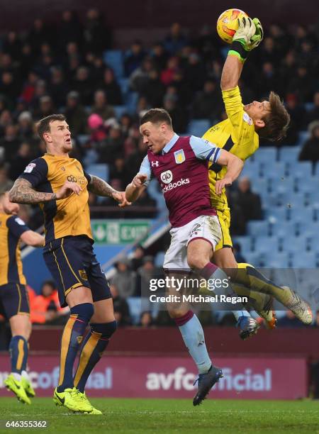Goalkeeper Fabian Giefer and Aden Flint of Bristol City defend against James Chester of Aston Villa during the Sky Bet Championship match between...