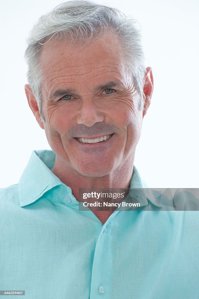 Middle Age Man Head Shot Smiling at Camera on Whit