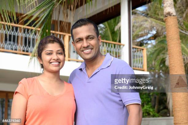 portrait of mid adult man and young woman smiling - tee srilanka stock pictures, royalty-free photos & images
