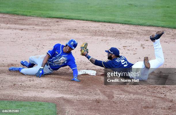 Jonathan Villar of the Milwaukee Brewers holds the ball up after tagging out Raul Mondesi of the Kansas City Royals at second base during the third...