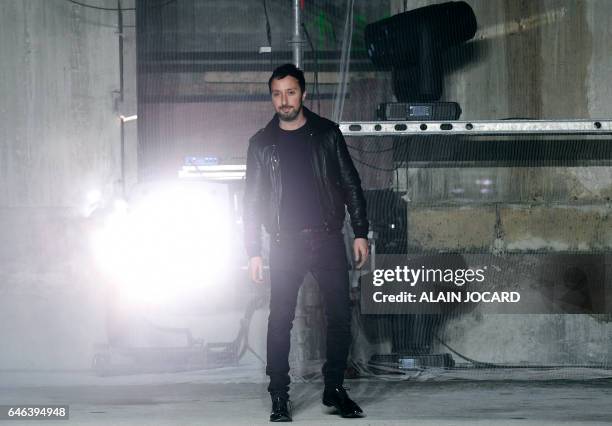 Creative director for Yves Saint-Laurent Anthony Vaccarello acknowledges the audience during the YSL Women's Fall-Winter 2017-2018 fashion week in...