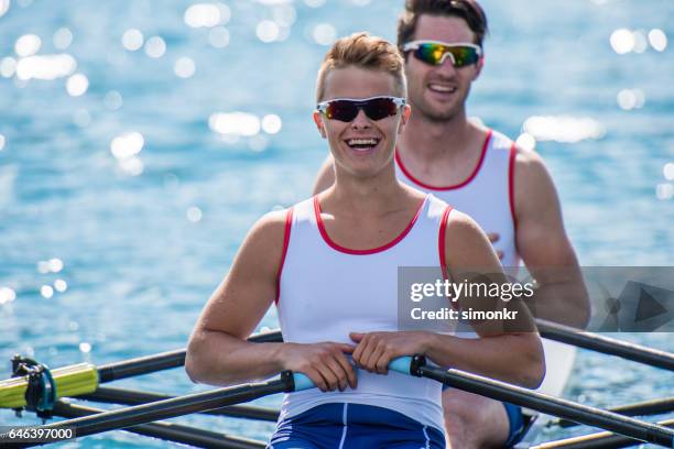 men rowing boat - single scull stock pictures, royalty-free photos & images