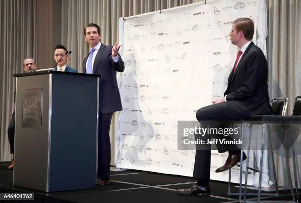 Eric Trump looks on as Donald Trump Jr. Delivers a speech during a ceremony for the official opening of the Trump International Tower and Hotel on...