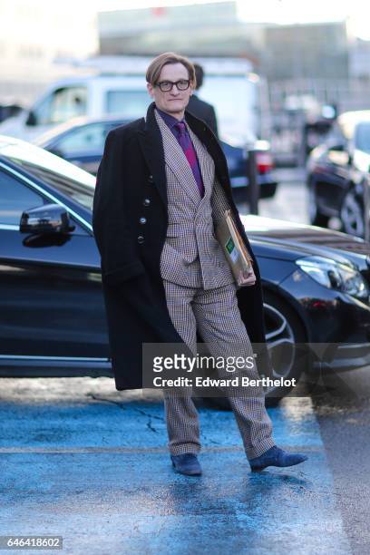 Guest wears a black coat, a purple tie, and a suit, outside the Olivier Theyskens show, during Paris Fashion Week Womenswear Fall/Winter 2017/2018,...