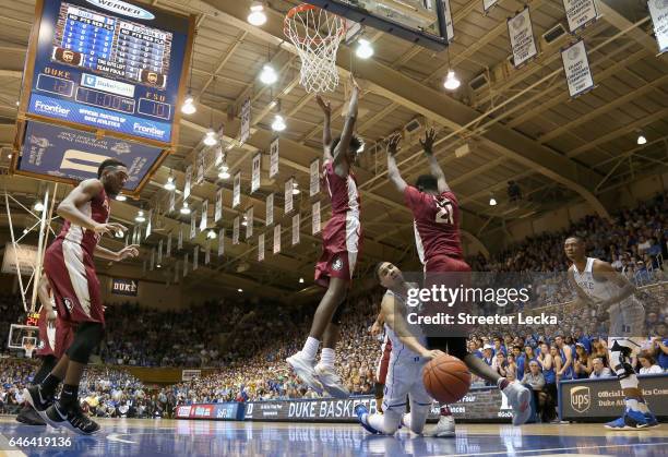 Jayson Tatum of the Duke Blue Devils collides with teammates Jonathan Isaac and Christ Koumadje of the Florida State Seminoles during their game at...