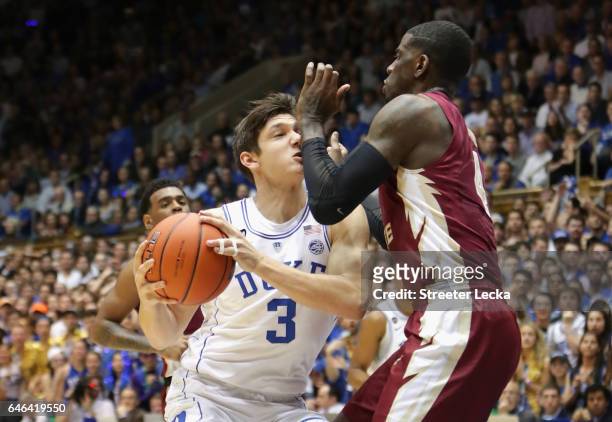 Grayson Allen of the Duke Blue Devils collides with Dwayne Bacon of the Florida State Seminoles during their game at Cameron Indoor Stadium on...
