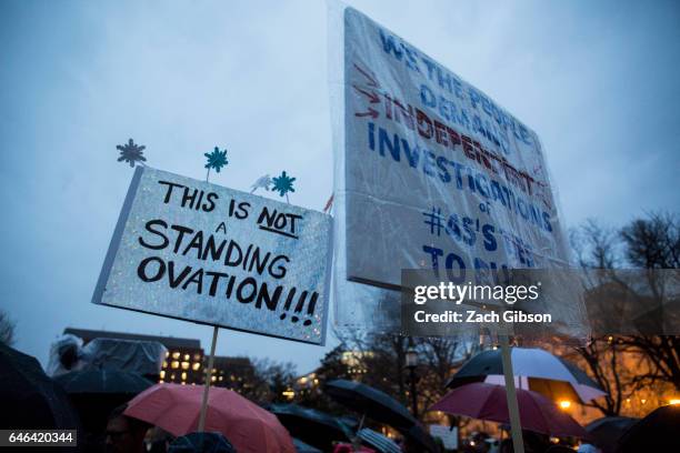 Demonstrators hold signs in Lafayette Square during a rally calling for resistance to President Donald Trump on February 28, 2017 in Washington, D.C....