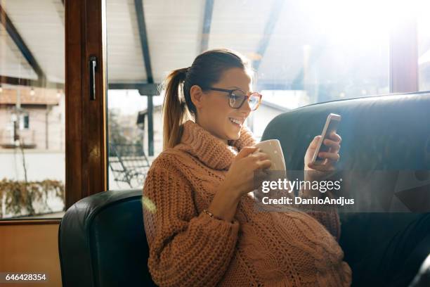 cheerful pregnant woman using her smartphone - life search stock pictures, royalty-free photos & images