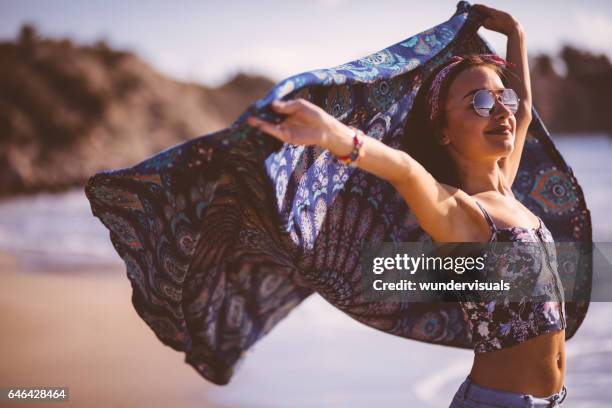 beautiful young woman with multi-colored scarf on the beach - cachecol imagens e fotografias de stock