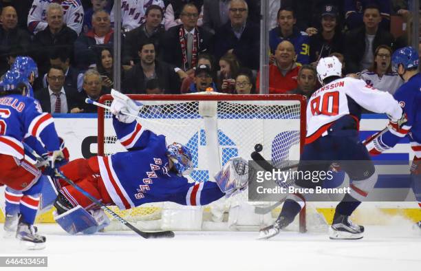 Marcus Johansson of the Washington Capitals scores at 7:28 of the second period against Henrik Lundqvist of the New York Rangers at Madison Square...
