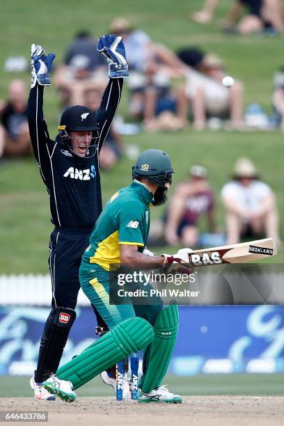 Hashim Amla of South Africa is bowled by Jeetan Patel of New Zealand as Luke Ronchi celebrates during game four of the One Day International series...