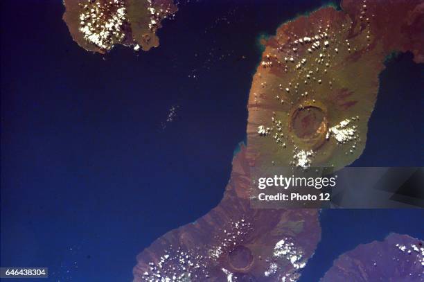 This image of the Galapagos Islands captures two large shield volcanoes on Isla Isabella, The northern volcano is Darwin and the southern, Alcedo....