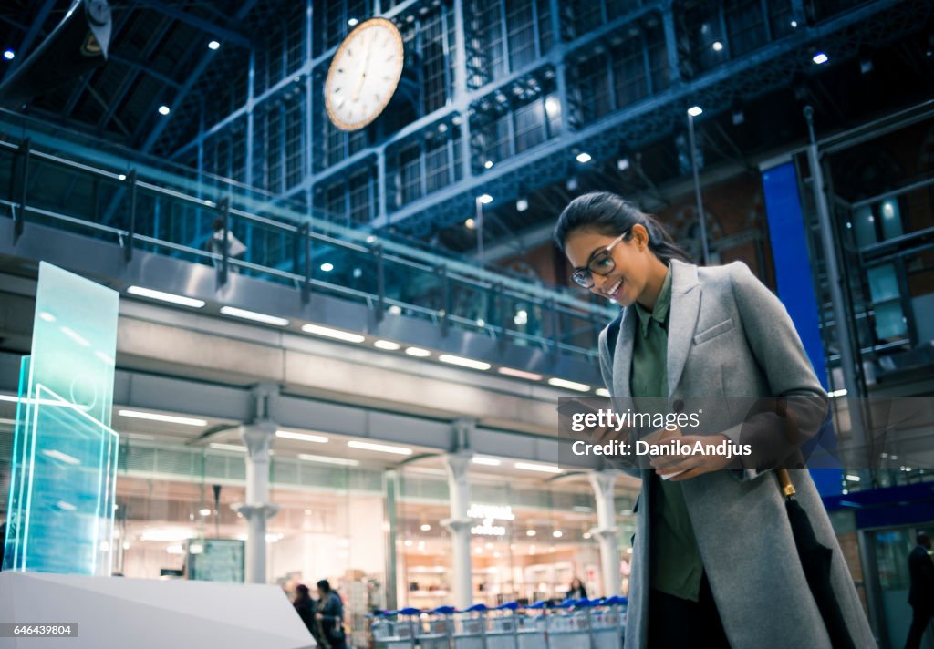 Cheerful businesswoman using her smartphone