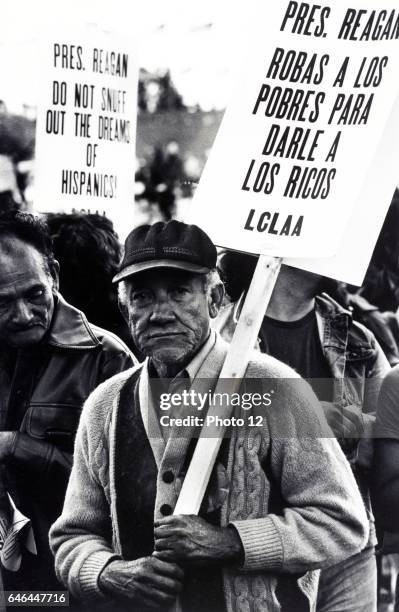 Reagan la roba a los pobres Migrant farm worker at a demonstration, Washington, D.C. Published 1981. Photograph shows an elderly man in the...