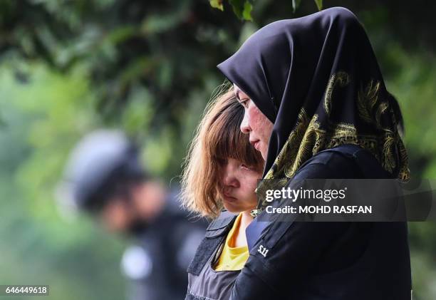 Vietnamese national Doan Thi Huong is escorted with a heavy police presence after a court appearance with Indonesian national Siti Aisyah at the...