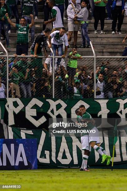 Colombian Deportivo Cali midfielder Nicolas Benedetti celebrates with a teammate after scoring against Paraguayan Sportivo Luqueno during their...